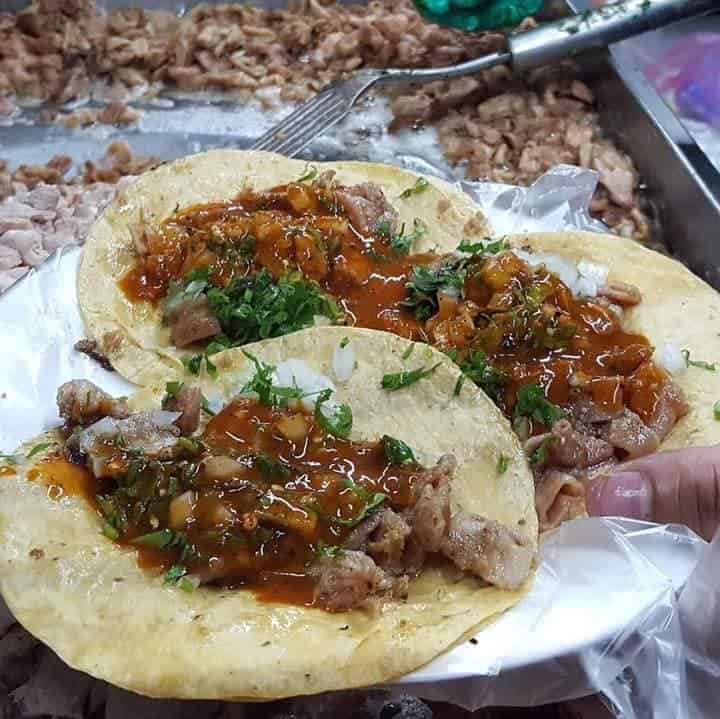 Pupusas tradicionales de Le&oacute;n, M&eacute;xico, con carne, salsa y cilantro, servidas en un puesto callejero.