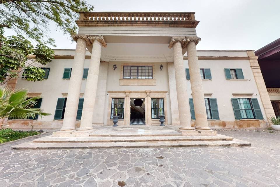 Fachada del antiguo palacio con columnas y detalles arquitectónicos clásicos en León, Guanajuato, ideal para turismo cultural.