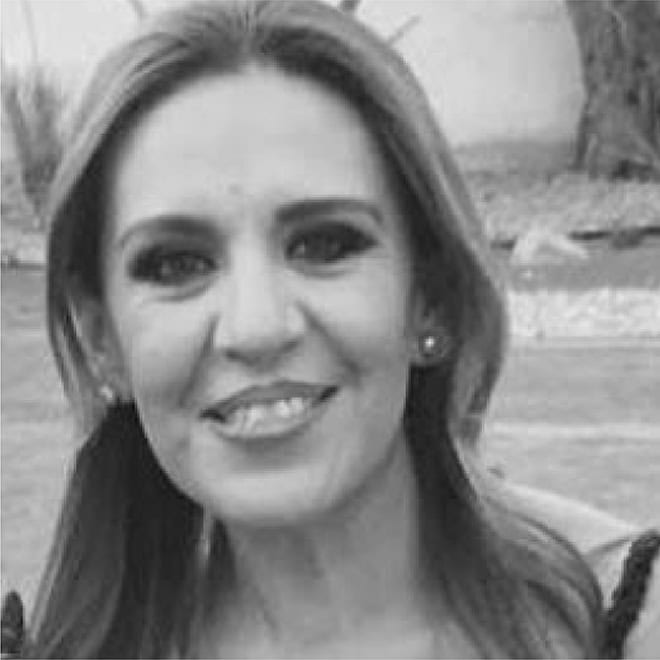 Mujer sonriendo en un parque de León, México, disfrutando del día al aire libre.