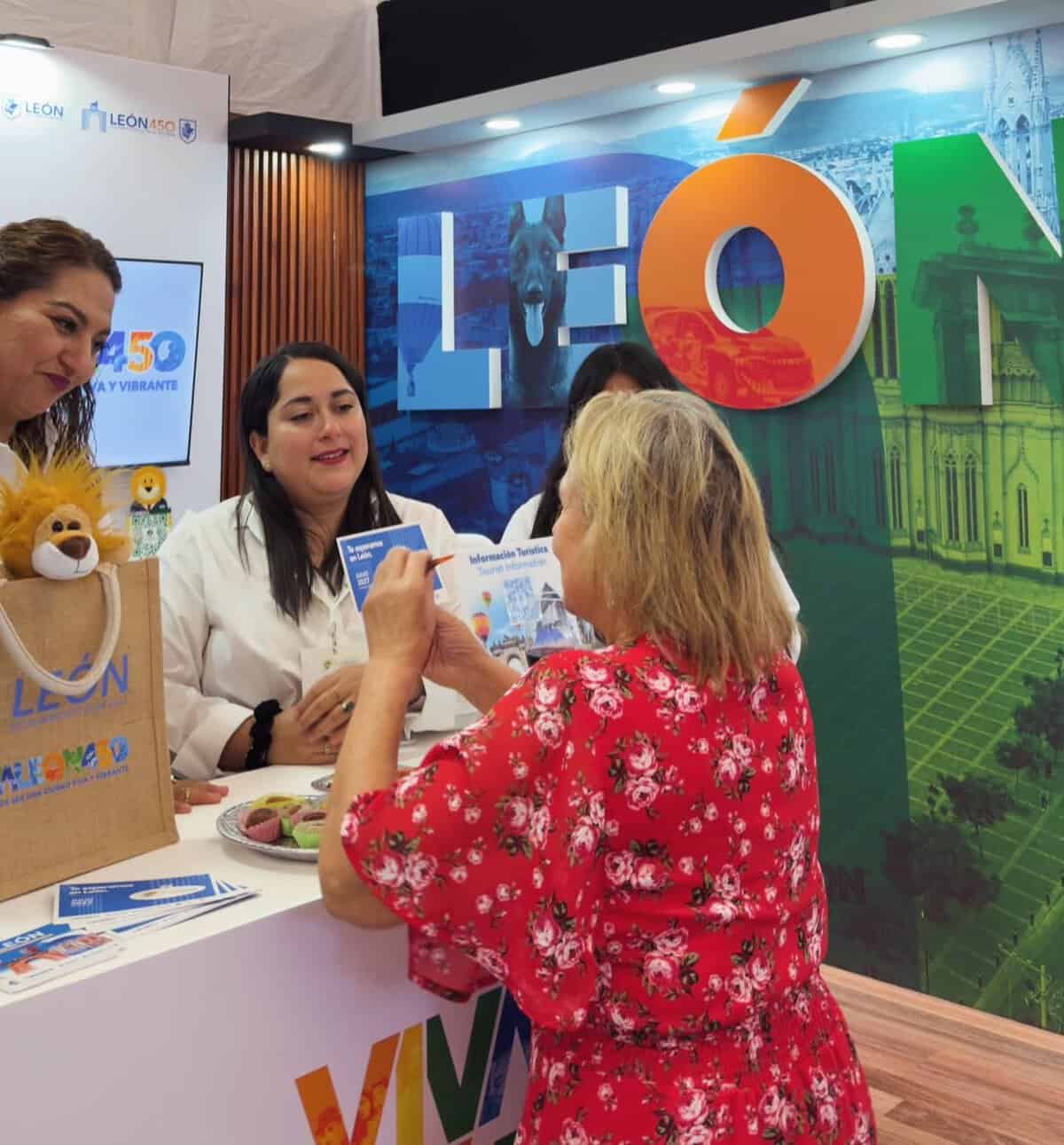 Visitantes en feria turística de León, Guanajuato, disfrutando de actividades culturales y promoción local.