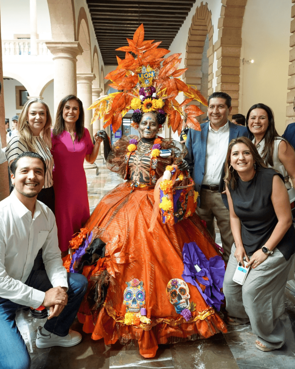 Group of people wearing traditional attire and skulls celebrating Day of the Dead in León, Guanajuato.
