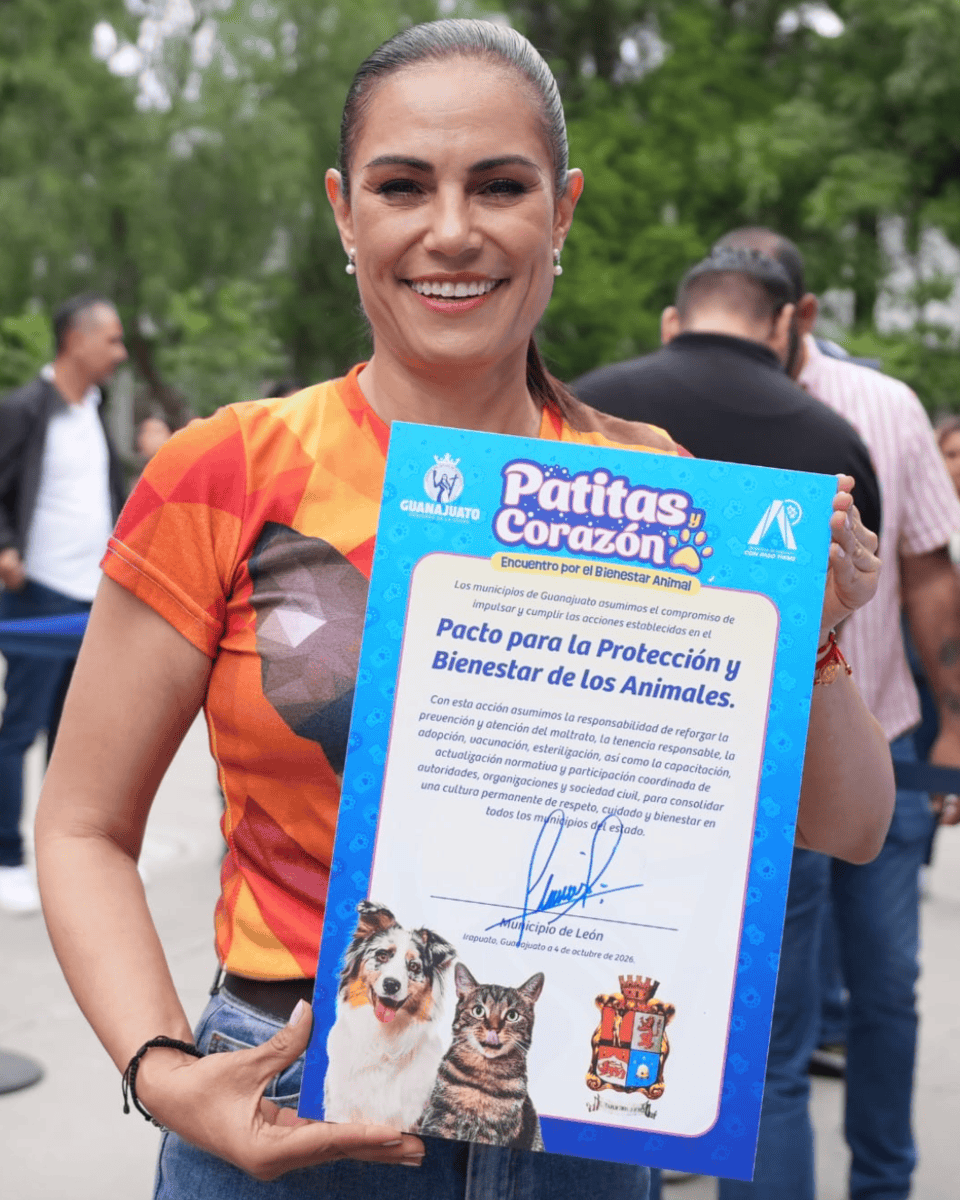 Woman in León showing a certificate of animal protection and welfare at a community event.